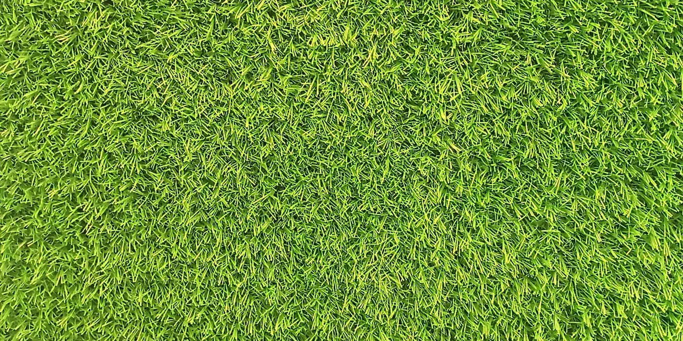 Close-up of bright green artificial grass fibres