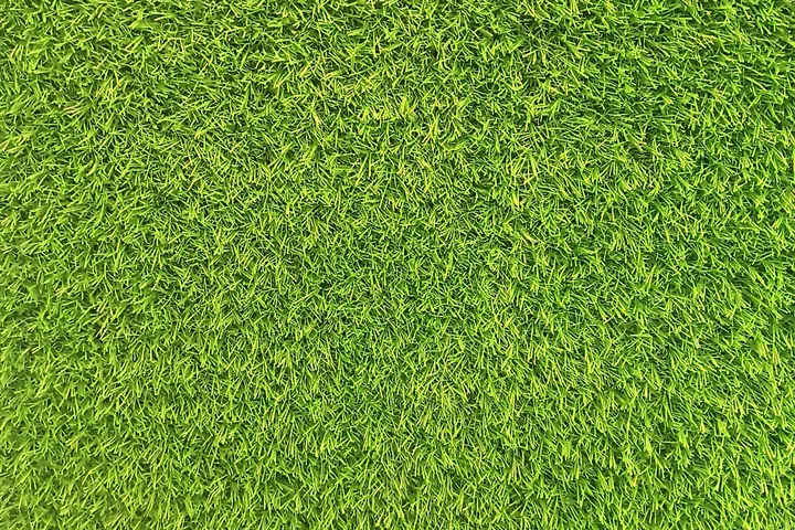 Close-up of bright green artificial grass fibres